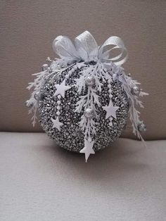 an ornament with snowflakes and stars on it is sitting on a table