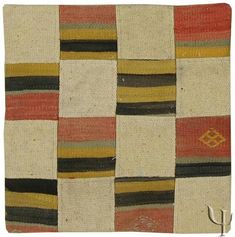 an old rug with different colored squares on it