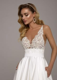 a woman wearing a white dress with lace detailing