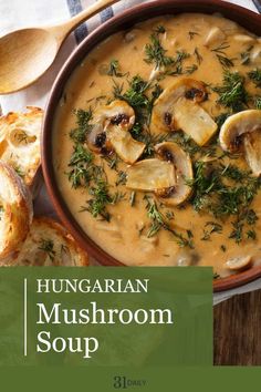 a bowl of mushroom soup with bread on the side