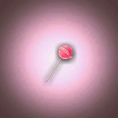 a pink lollipop on a purple background with the light reflecting off it's surface