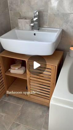 a bathroom with a sink and wooden cabinet