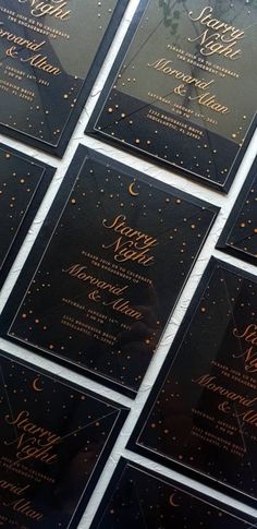 there are many black and gold wedding cards