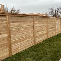 a wooden fence is shown in the grass