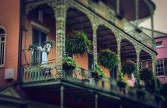 an ornate balcony with potted plants on the balconies