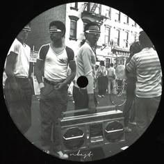 black and white photograph of men standing in front of a truck with people around it