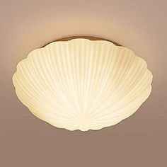 a light that is on the ceiling in a room with beige walls and flooring