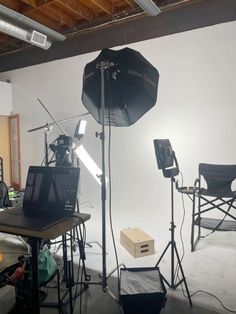 an empty room with several lighting equipment in it