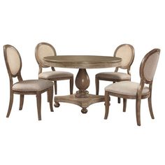 a dining room table with four chairs and a small round wooden table in the middle