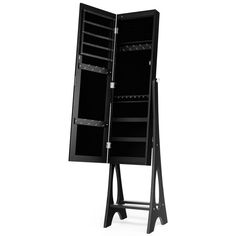 a black easel with an open door and shelves on the front, sitting against a white background