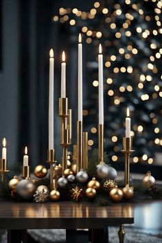 a table topped with lots of candles next to christmas balls and ornaments on top of it