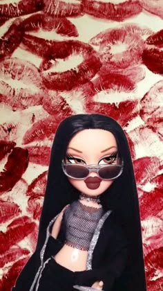 a doll wearing sunglasses and a black outfit with red lipstick on the lips is standing in front of a painting