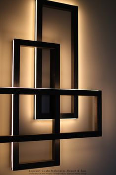 the light is shining on an art piece that appears to be made out of wood and metal