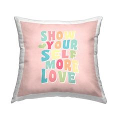 a pink pillow with the words show your self more love in multicolored letters