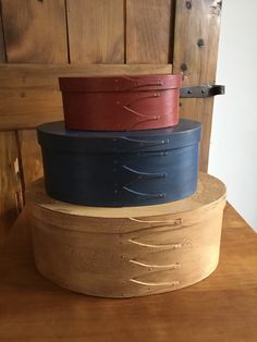 three wooden bowls stacked on top of each other