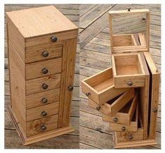 two wooden drawers are stacked on top of each other and one drawer is open to show the contents