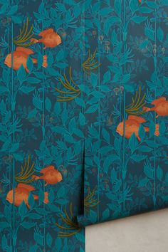 the wallpaper is blue with orange fish on it