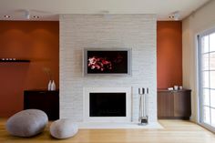 a living room with a fire place and two large rocks