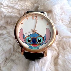 a watch with an image of stitch - o - life on the face and glasses