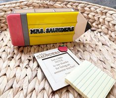 a yellow and red box sitting on top of a table next to a piece of paper