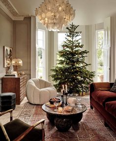 a living room filled with furniture and a christmas tree in the middle of the room