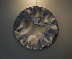 a circular mirror hanging on the wall