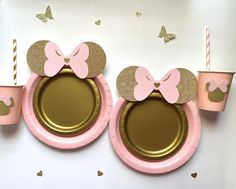 pink and gold paper plates with minnie mouse ears on them, sitting next to cups