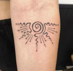 a woman's arm with a tattoo on it that has an image of a sun and clouds