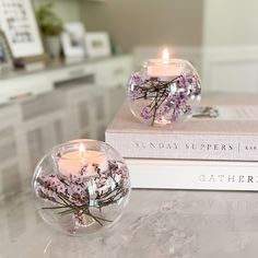 two vases filled with flowers sitting on top of a table