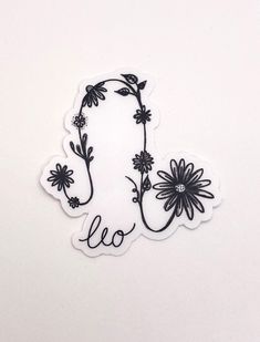 a sticker with flowers and the word leo written in cursive writing on it