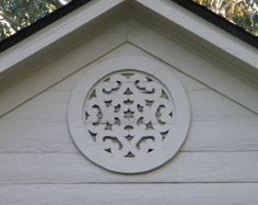 a white building with a circular window on the side