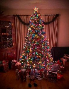 a brightly lit christmas tree in a living room