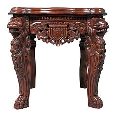 an ornate wooden table with carvings on the top and bottom, against a white background