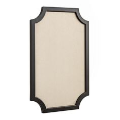 a black and white framed mirror on a wall with a beige fabric covering over it