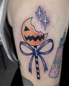 a halloween themed tattoo with a candy bar and jack - o'- lantern on it