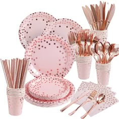 a table setting with pink polka dot plates and silverware