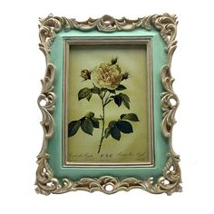 a painting of a flower in a frame on a white wall with green trimmings