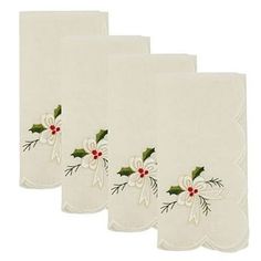 three white christmas napkins with holly and mist