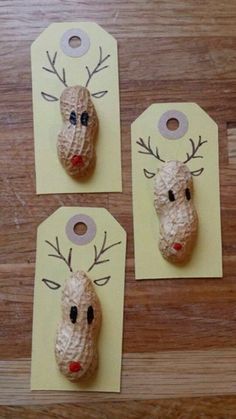 paper mache reindeers are sitting on top of yellow tags with red nose and antlers