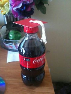 a bottle of coca cola sitting on top of a wooden table