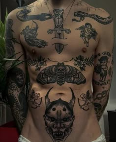 a man with lots of tattoos on his chest