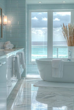 a large white bath tub sitting in a bathroom next to a window with ocean view