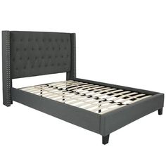 an upholstered bed frame with buttons on the headboard and foot board is shown