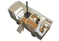 the tiny house is on wheels with stairs leading up to the kitchen and living area