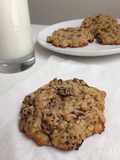 two cookies and a glass of milk on a table