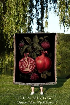 a pomegranate and leaves on a black blanket