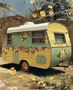 an old yellow and green camper parked on the side of a road next to trees