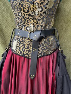 a corset made out of fabric and leather with metal buckles on it