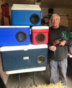 a man standing next to some speakers in a garage