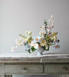 a vase filled with flowers sitting on top of a table